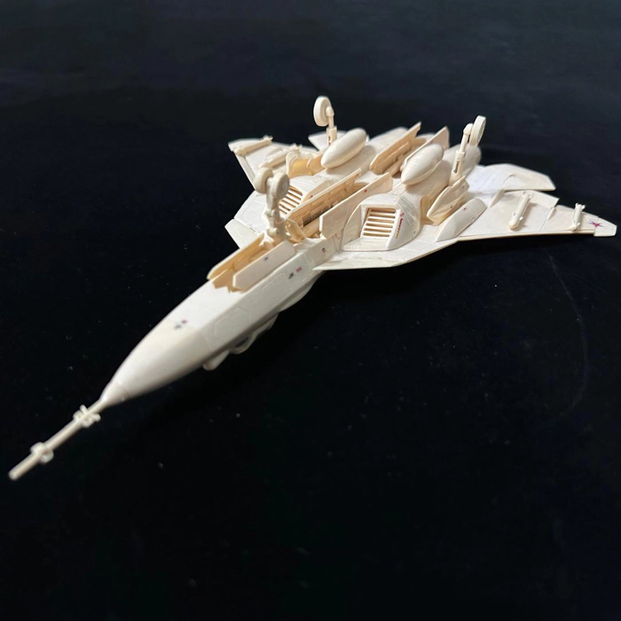 A composite model of the SU-57 mammoth tusk aircraft on a stand